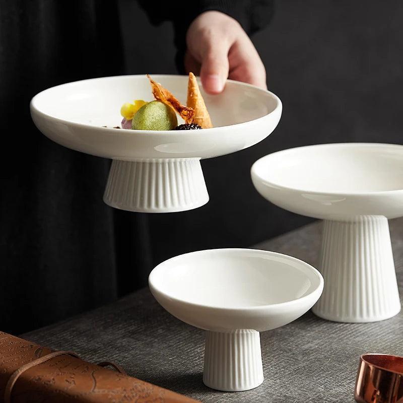 White pedestal fruit bowl styled with green mousse dessert