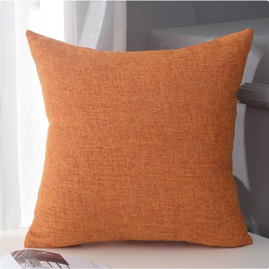 Terracotta orange solid linen accent pillow on white surface