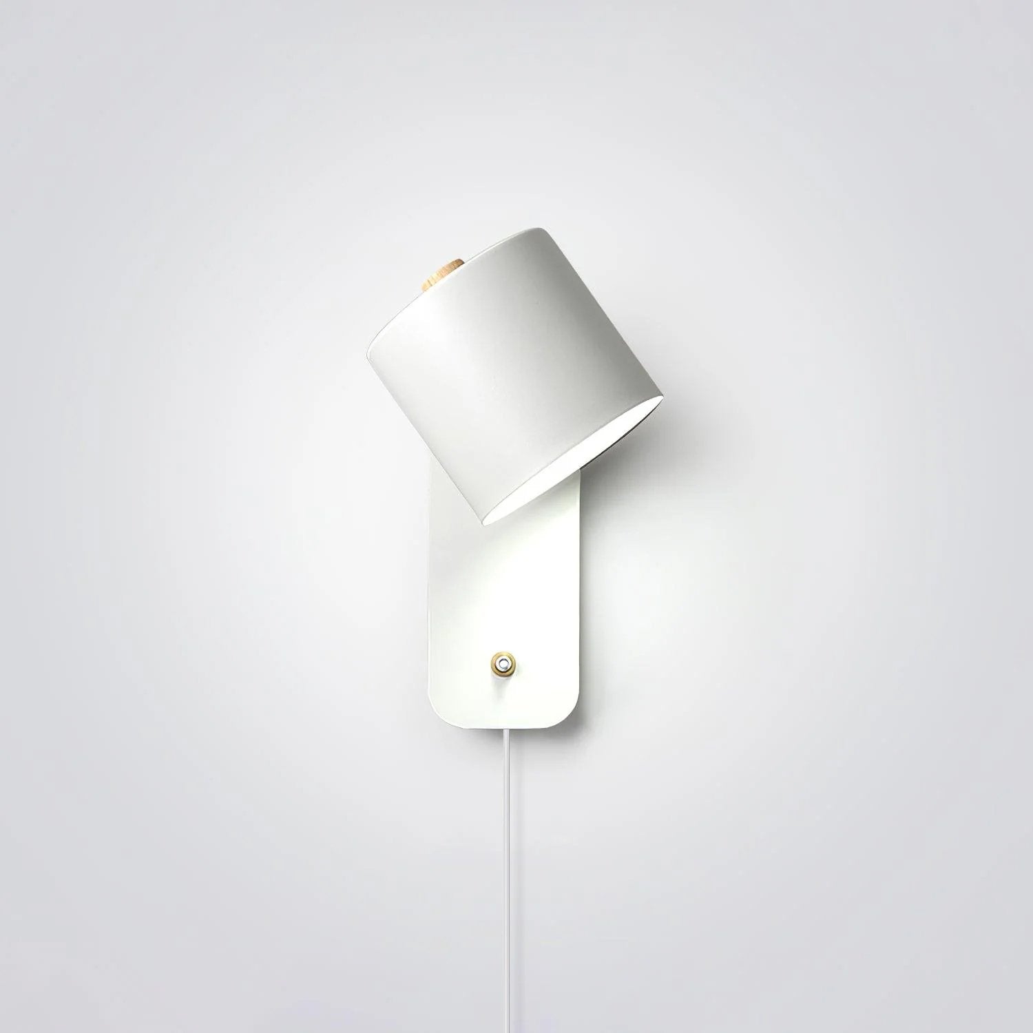White matte cylindrical plug-in wall lamp on white background