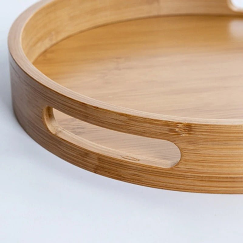 Round bamboo serving tray close-up showing smooth polished edge and integrated oval cutout handle