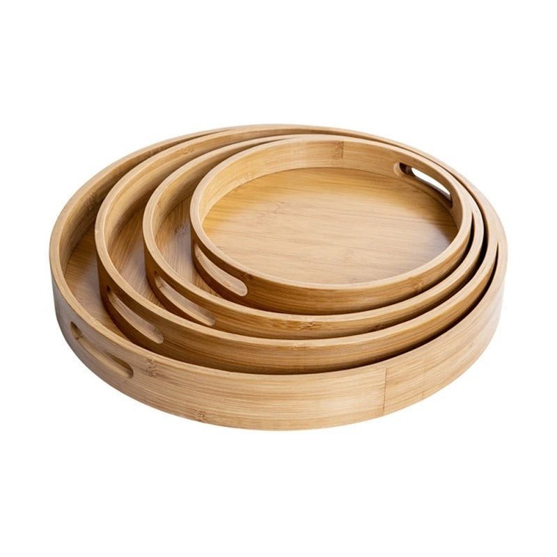 Stacked set of three round bamboo serving trays in varying sizes with natural wood grain