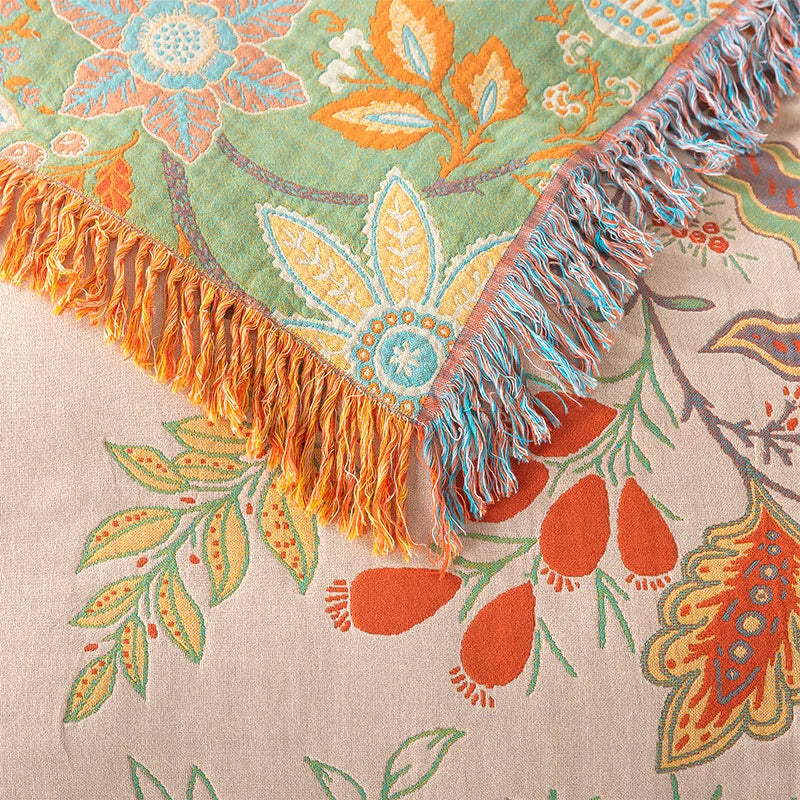 Close-up of multicolored fringe and woven cotton texture on rustic floral bedding