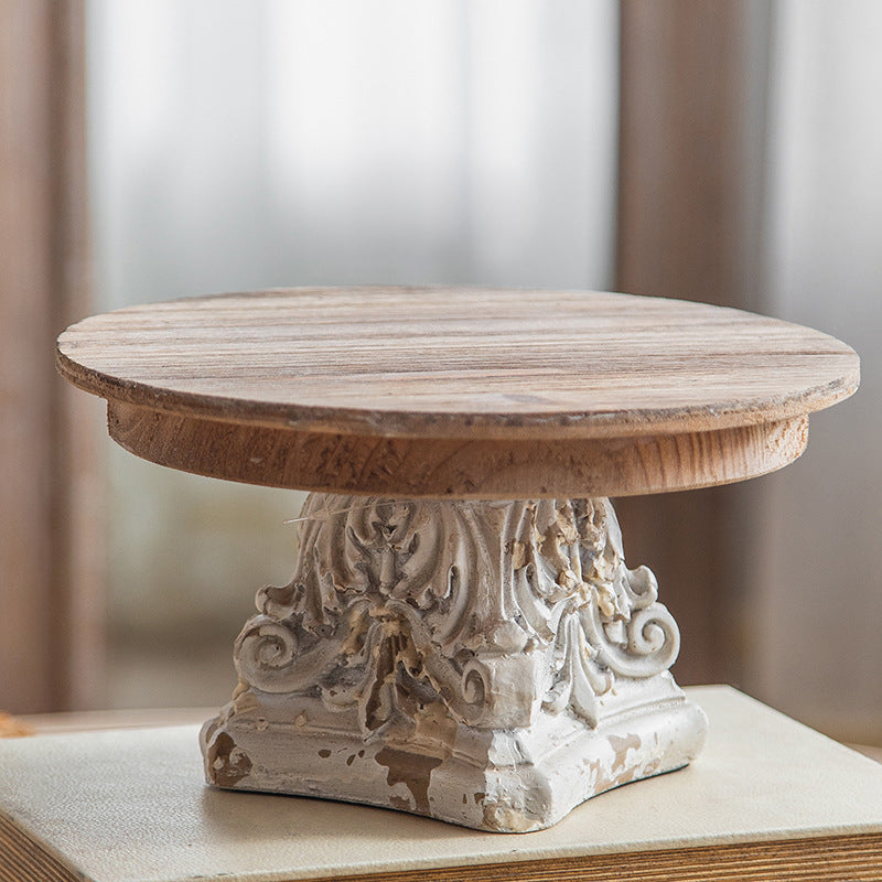 Hand-finished wooden top with knot on vintage cream-colored display stand
