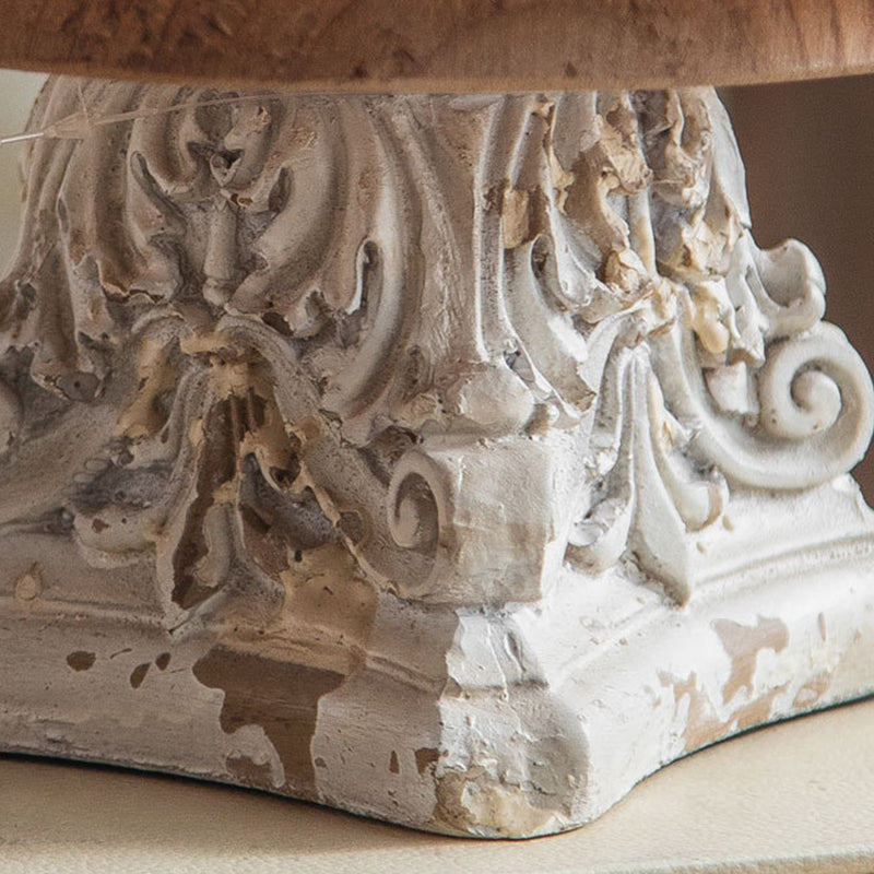 Intricate acanthus leaf carvings on chipped white painted pedestal base
