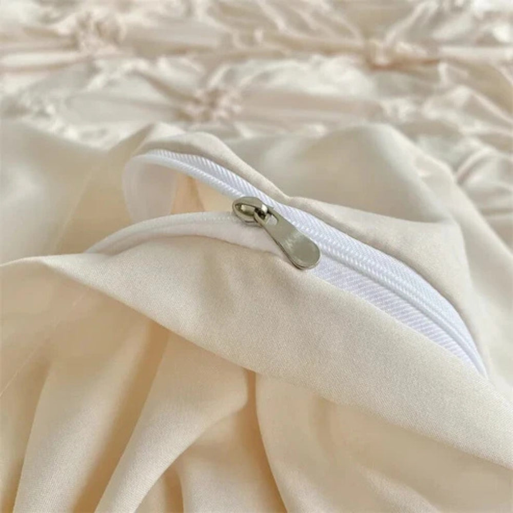 Close-up of white zipper detail on cream microfiber duvet cover