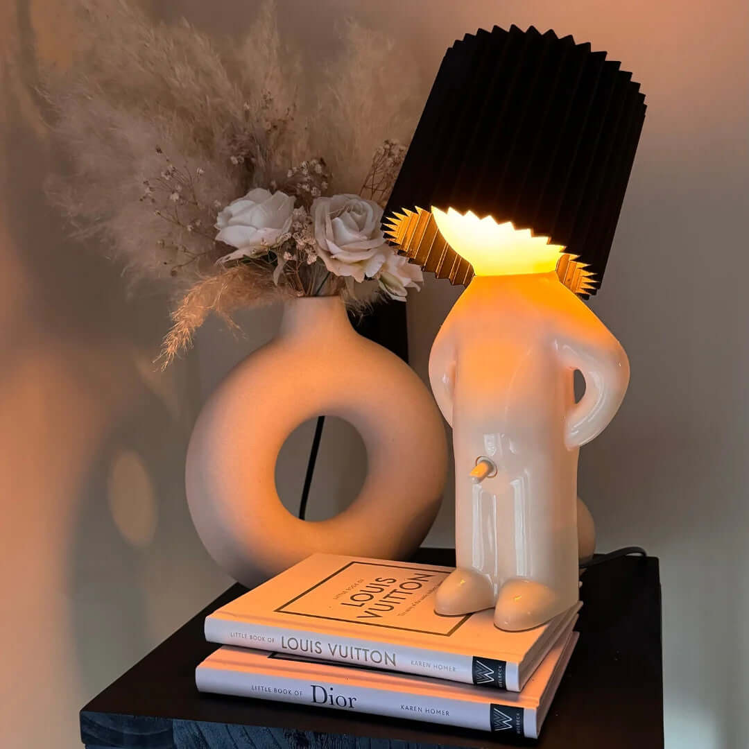 Black pleated lampshade on white ceramic character night light figure