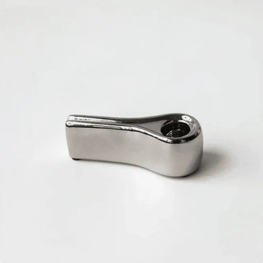 Close-up of sculptural silver metal candle accessory with ridged texture