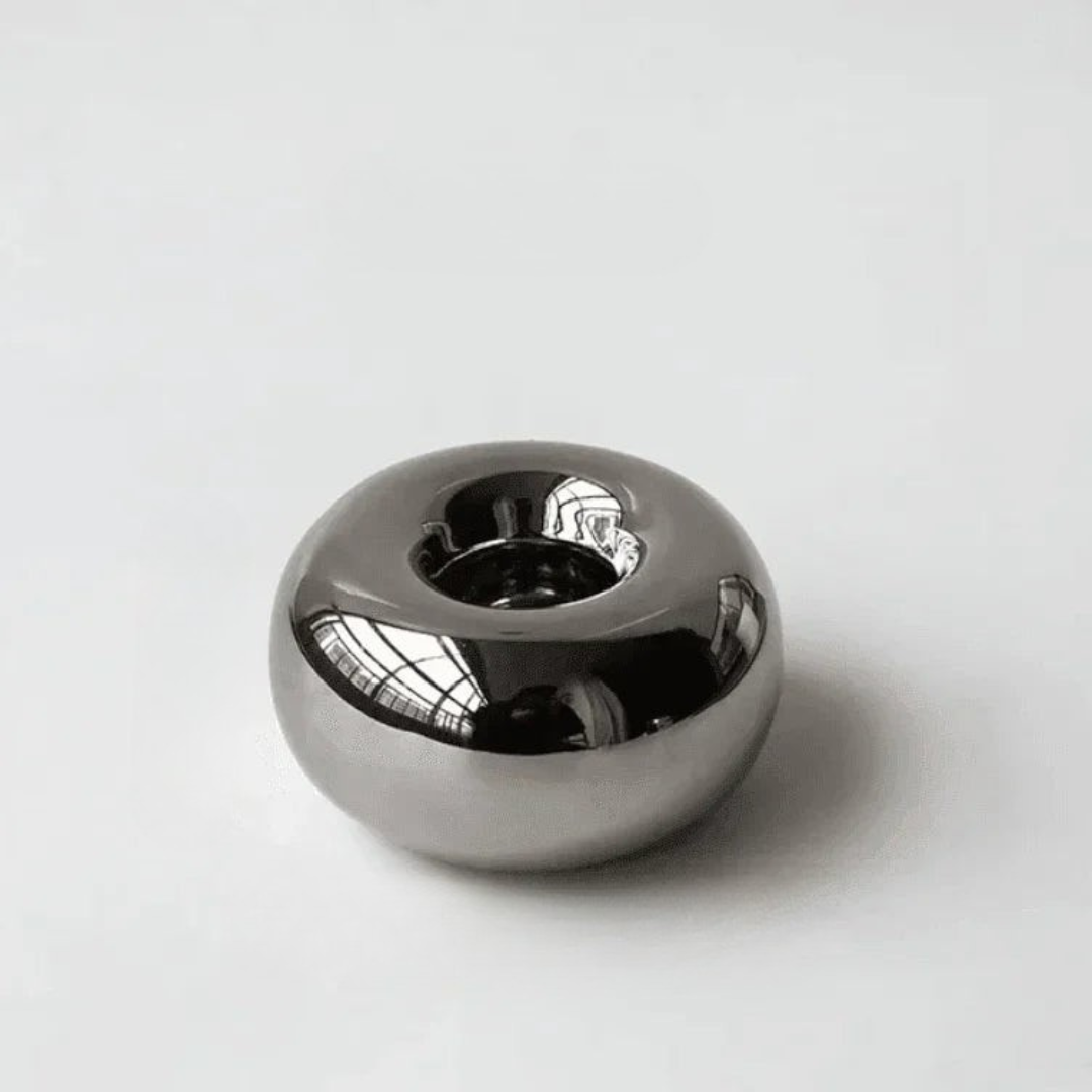 Silver ceramic pebble tealight holder with high-gloss chrome finish