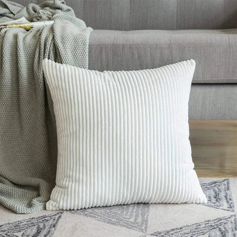 Off-white corduroy cushion cover with vertical ribs on gray geometric rug