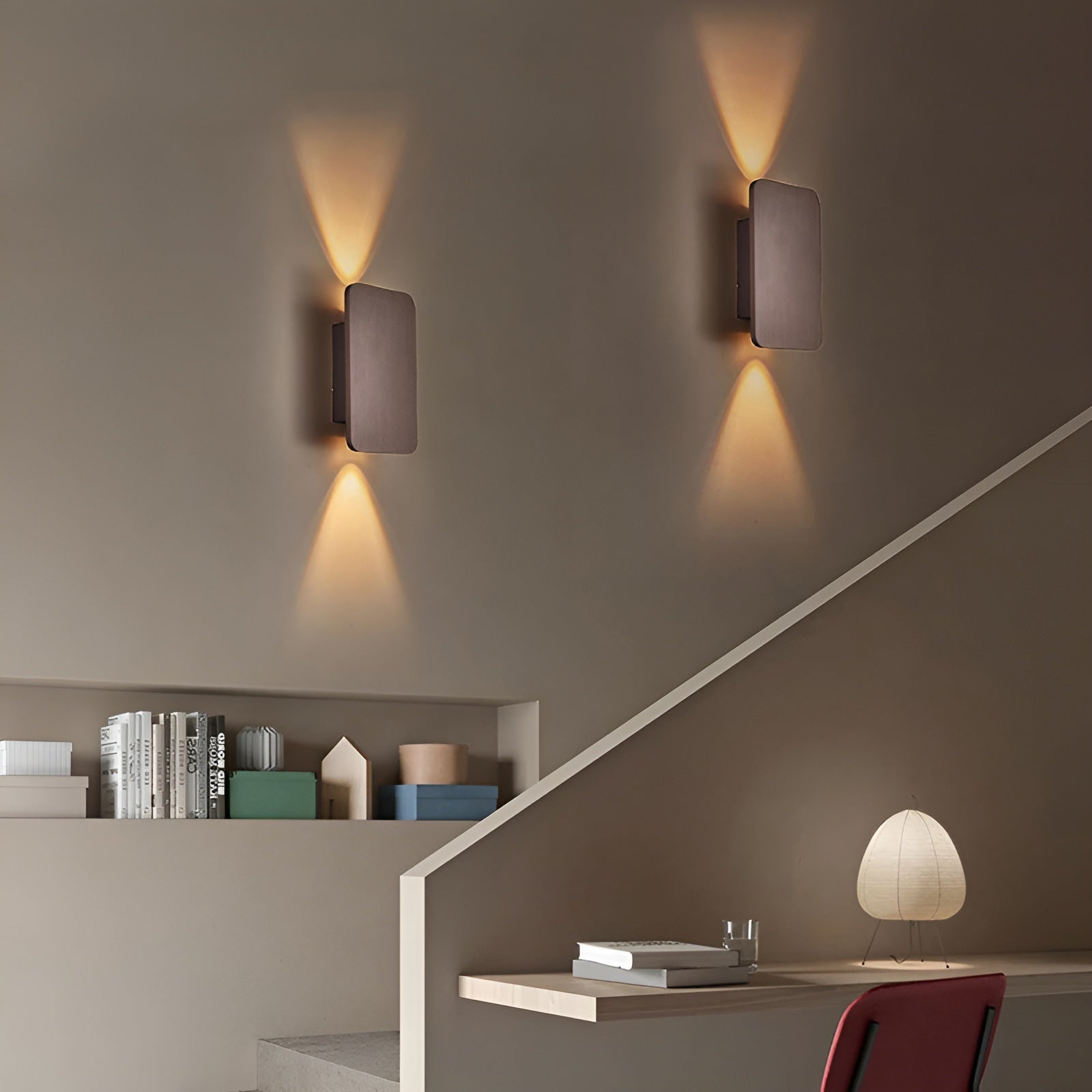 Bronze and brown dual beam wall sconces mounted beside staircase in modern hallway