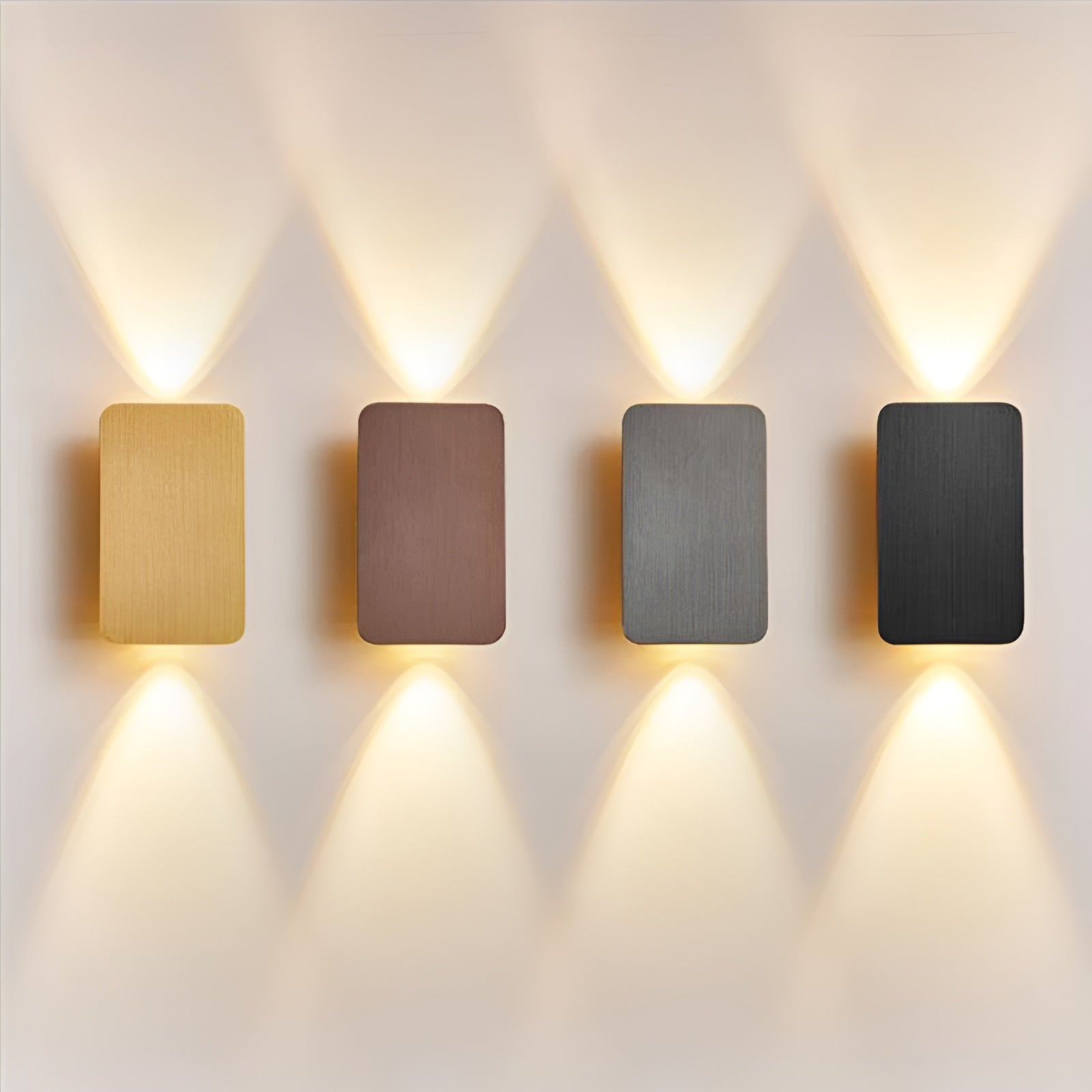 Set of four brushed metallic wall sconces in gold, bronze, silver, and black