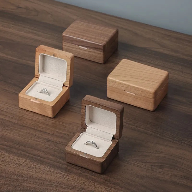 Set of light and dark wood ring boxes with cream velvet interiors