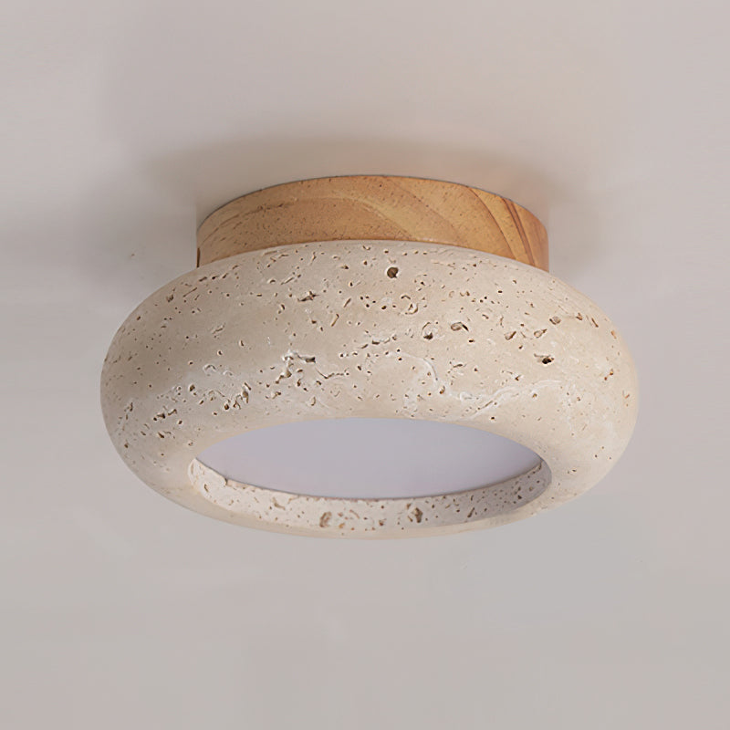 Round travertine stone ceiling lamp showing porous texture detail