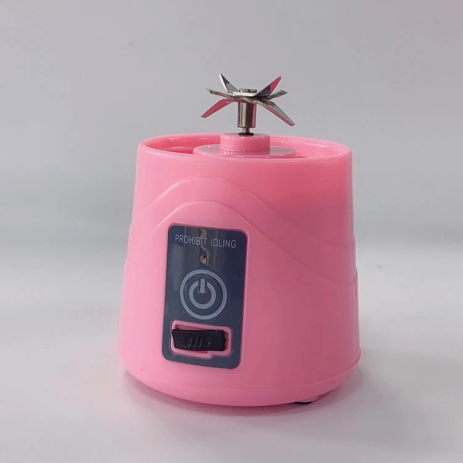 Pink motor base of portable blender with ON-OFF switch and stainless steel blades