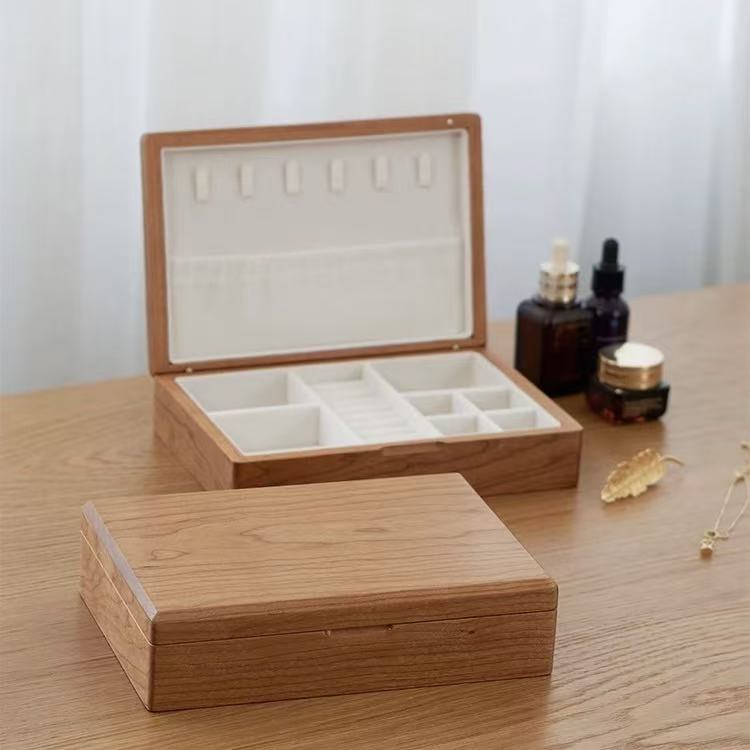 Open walnut jewelry box with velvet lining and tiered ring slots