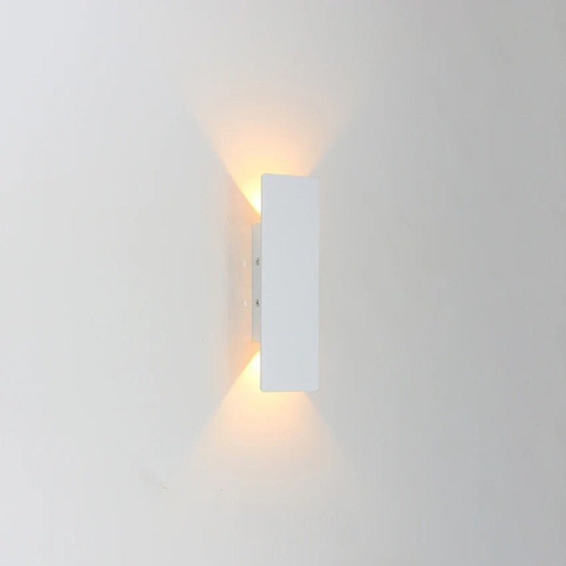 Close-up white minimalist LED wall sconce with mounting bracket