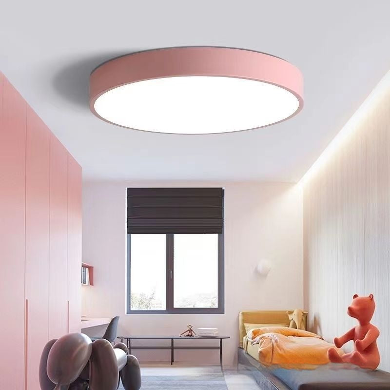 Maintained House Macaron Flush Mount LED Ceiling Light - Pink in a pink-walled bedroom