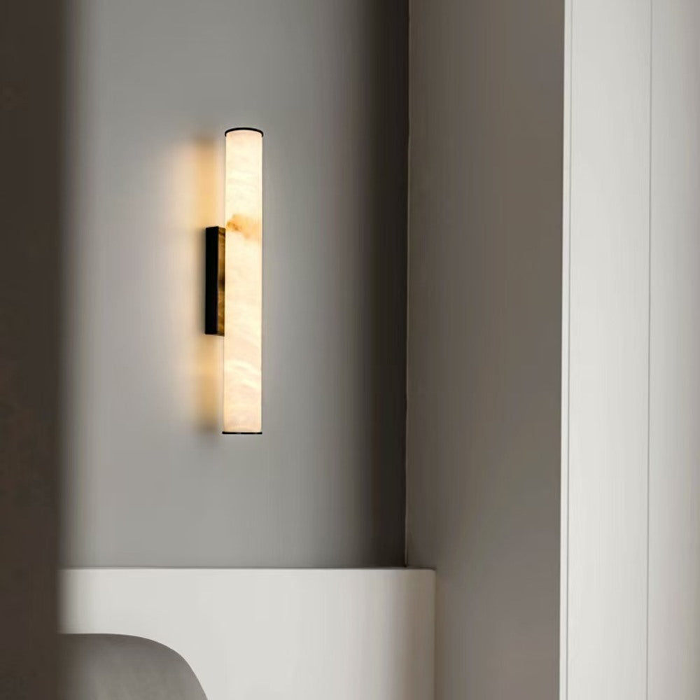 Maintained House Marble Tube Wall Sconce - Lit on a bedroom wall by a wardrobe