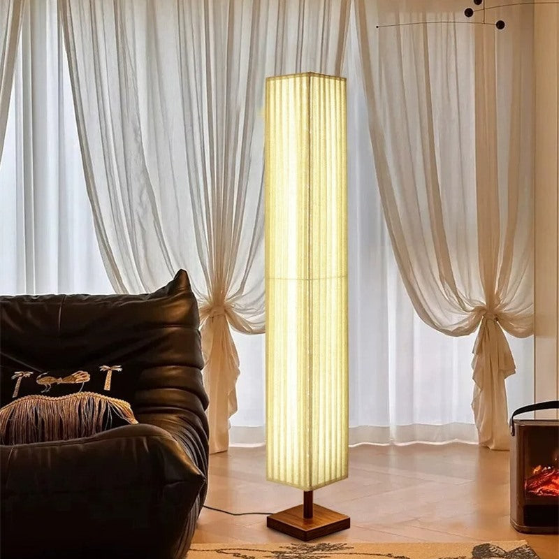 Maintained House Pleated Linen Column Floor Lamp - Lit in front of sheer curtains