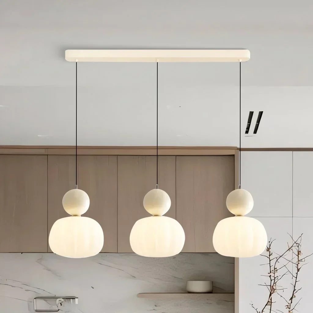 Maintained House Pumpkin Pendant Light - 3-Light Bar in Cream above a kitchen counter
