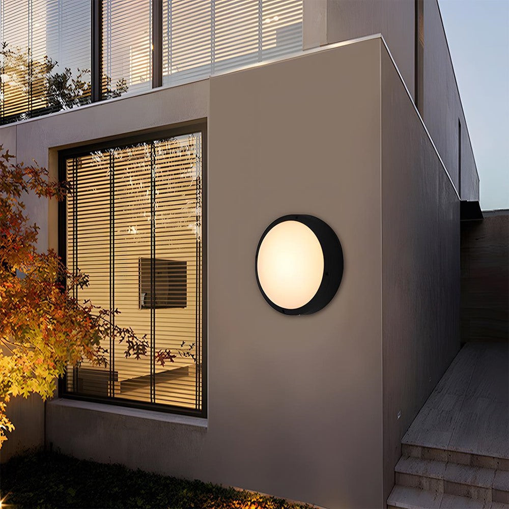 Maintained House Round Outdoor LED Wall Light - Plain style on a modern house exterior