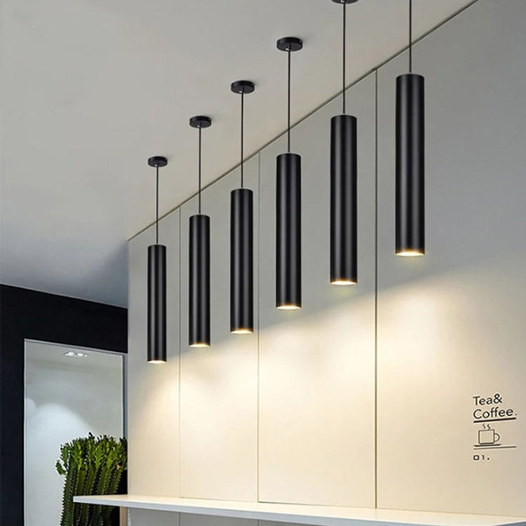 Maintained House Slim Tube LED Pendant Light - Black tubes in a row above a counter