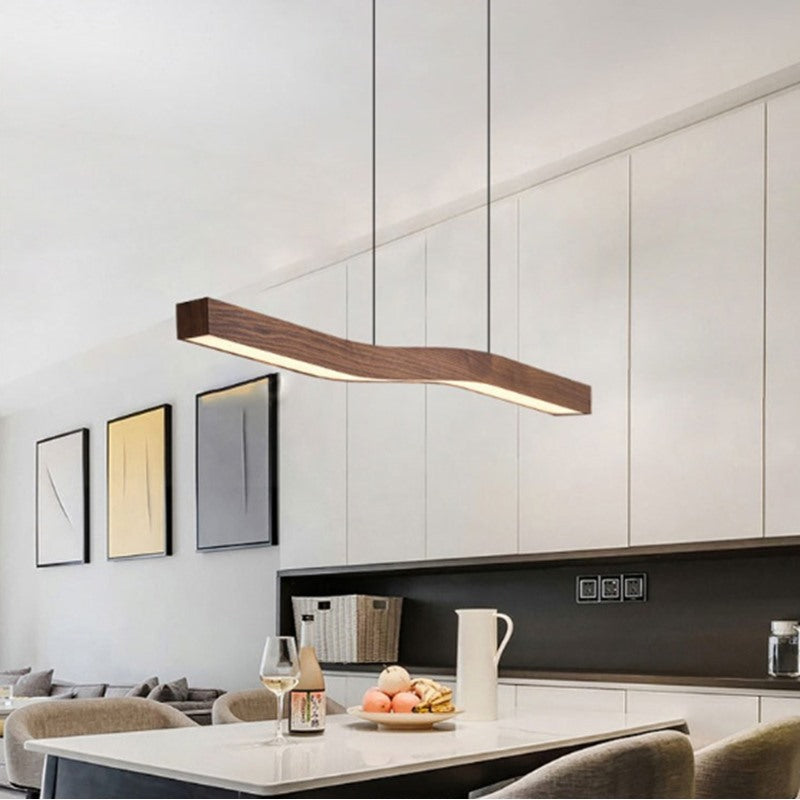 Maintained House Wavy Walnut-Finish Linear Pendant Light - Over a kitchen island
