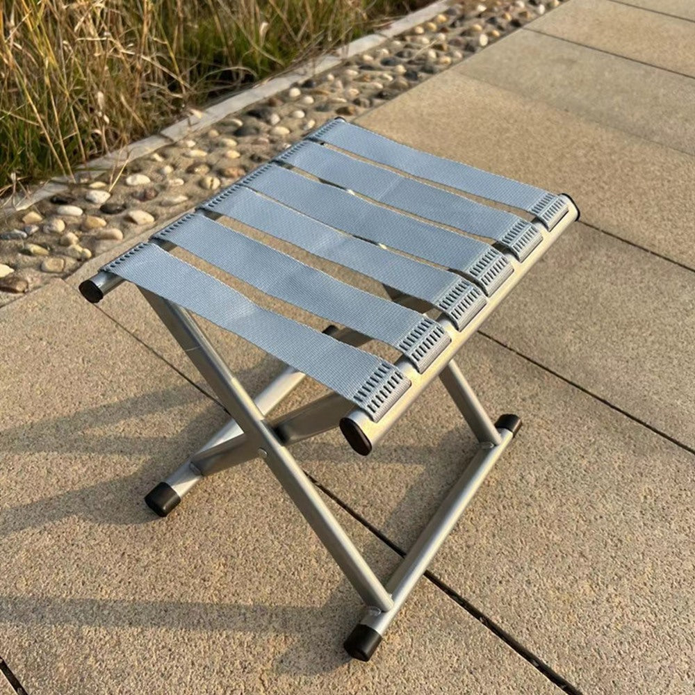 Maintained House Webbing Seat Folding Stool - Silver on a deck