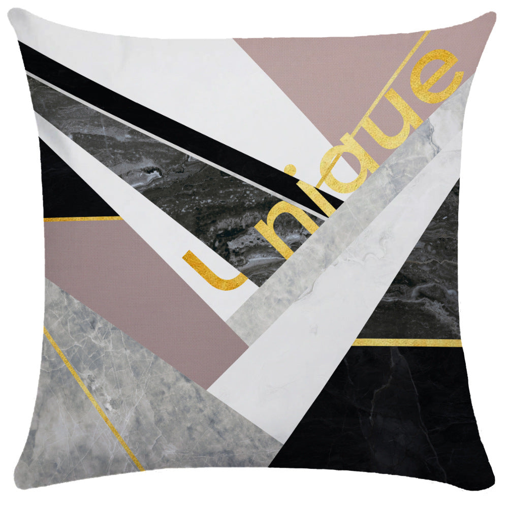Mauve and gray marbled geometric pillow cover with diagonal 'unique' gold text overlay