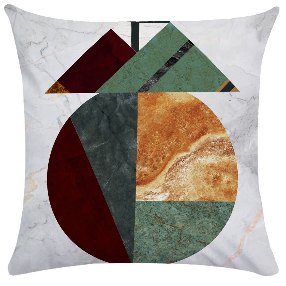 Stone-textured color block pillow cover with central circle and triangular gold trim