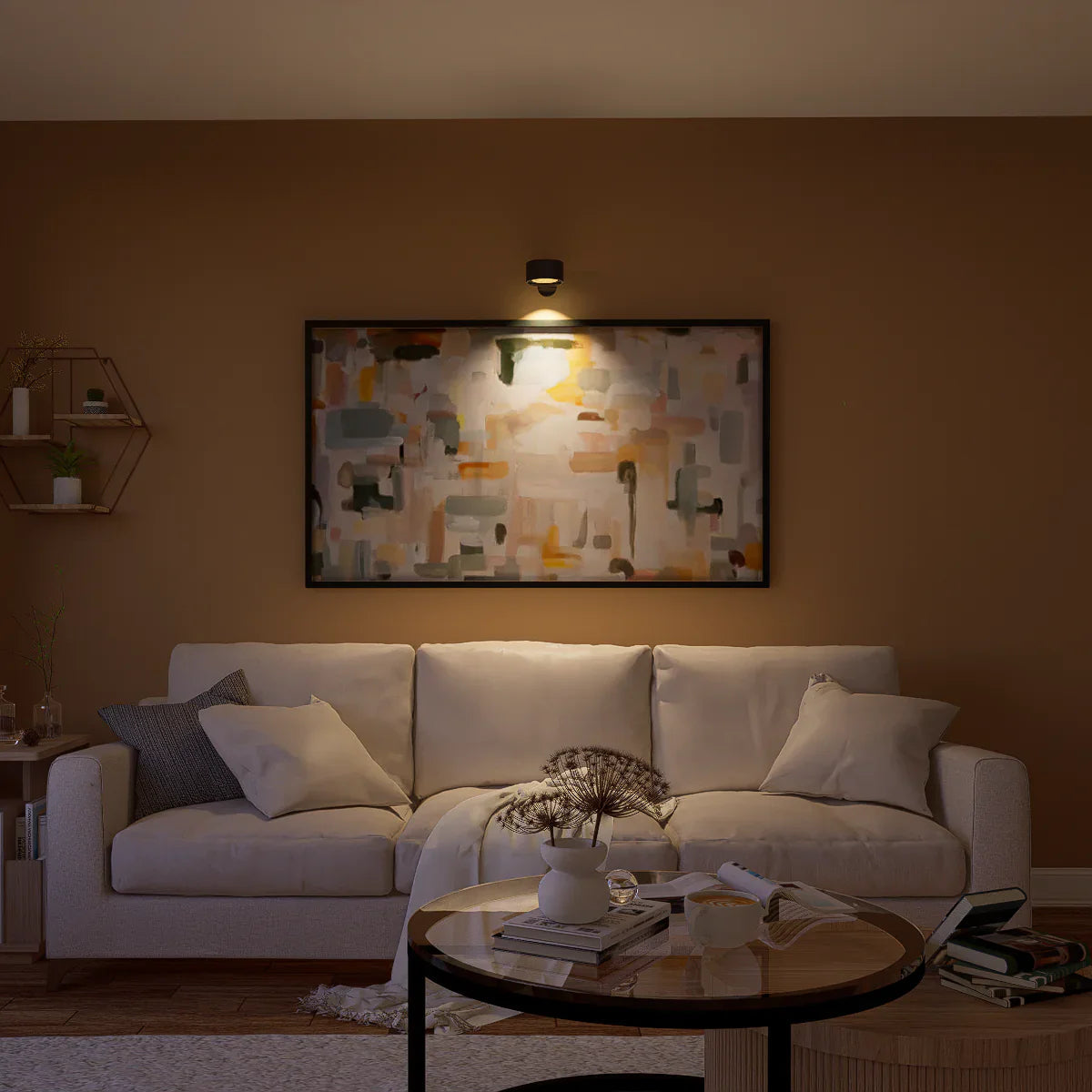 Black spotlight wall light highlighting abstract art in living room