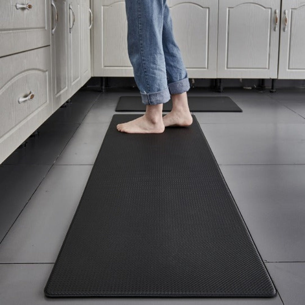 Black cushioned kitchen runner mat with diamond texture and raised edges