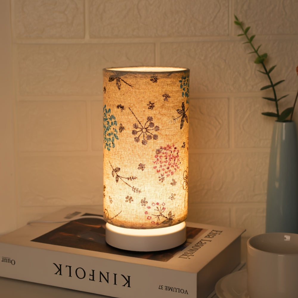 Cottagecore cylinder table lamp with blue and brown insect motifs on fabric shade