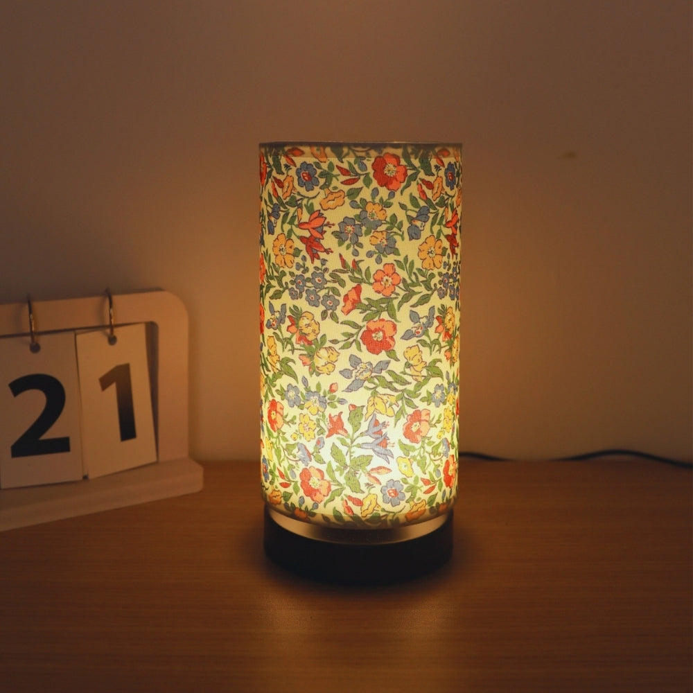 Colorful millefleurs table lamp with orange and yellow flowers on black base