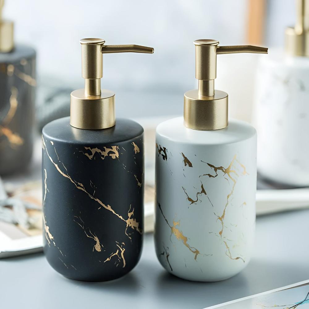 Black and white ceramic soap dispensers with gold marble pattern side by side