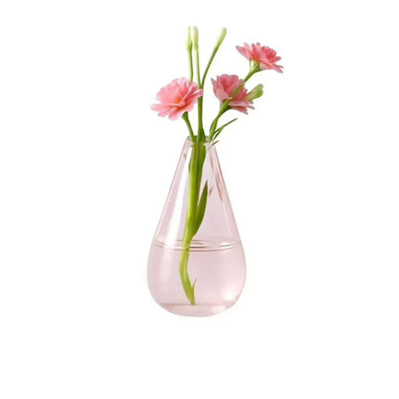 translucent pink teardrop glass magnet vase with water and pink carnations