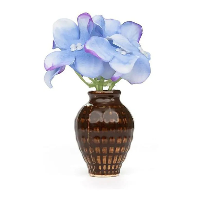 brown grid-textured ceramic magnet vase with blue hydrangea