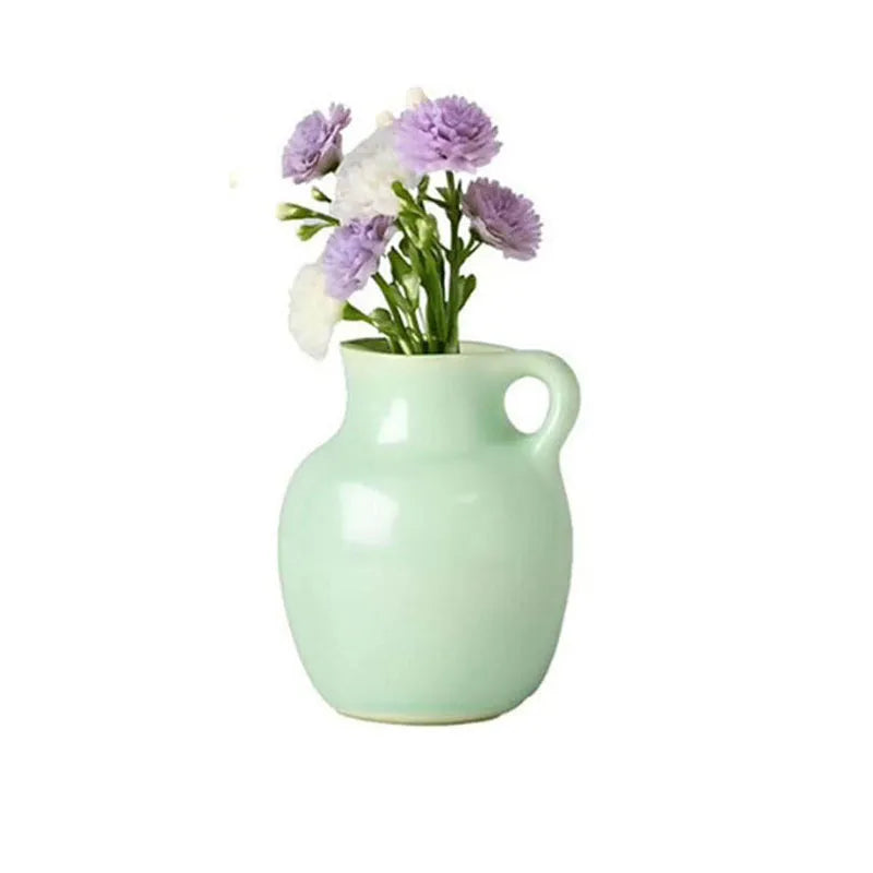 mint green ceramic magnet vase with side handle and purple carnations