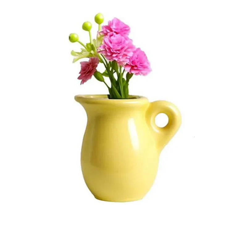 yellow ceramic pitcher magnet vase with circular handle and pink carnations