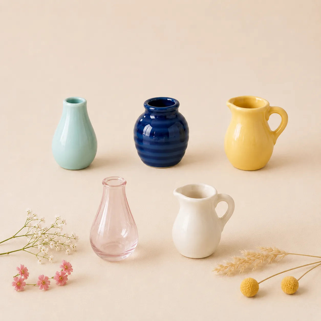 mini ceramic vase magnets in blue, yellow, pink, and white on beige surface