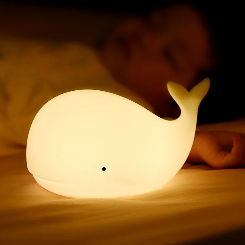 Rechargeable whale night light casting soft glow in child's room