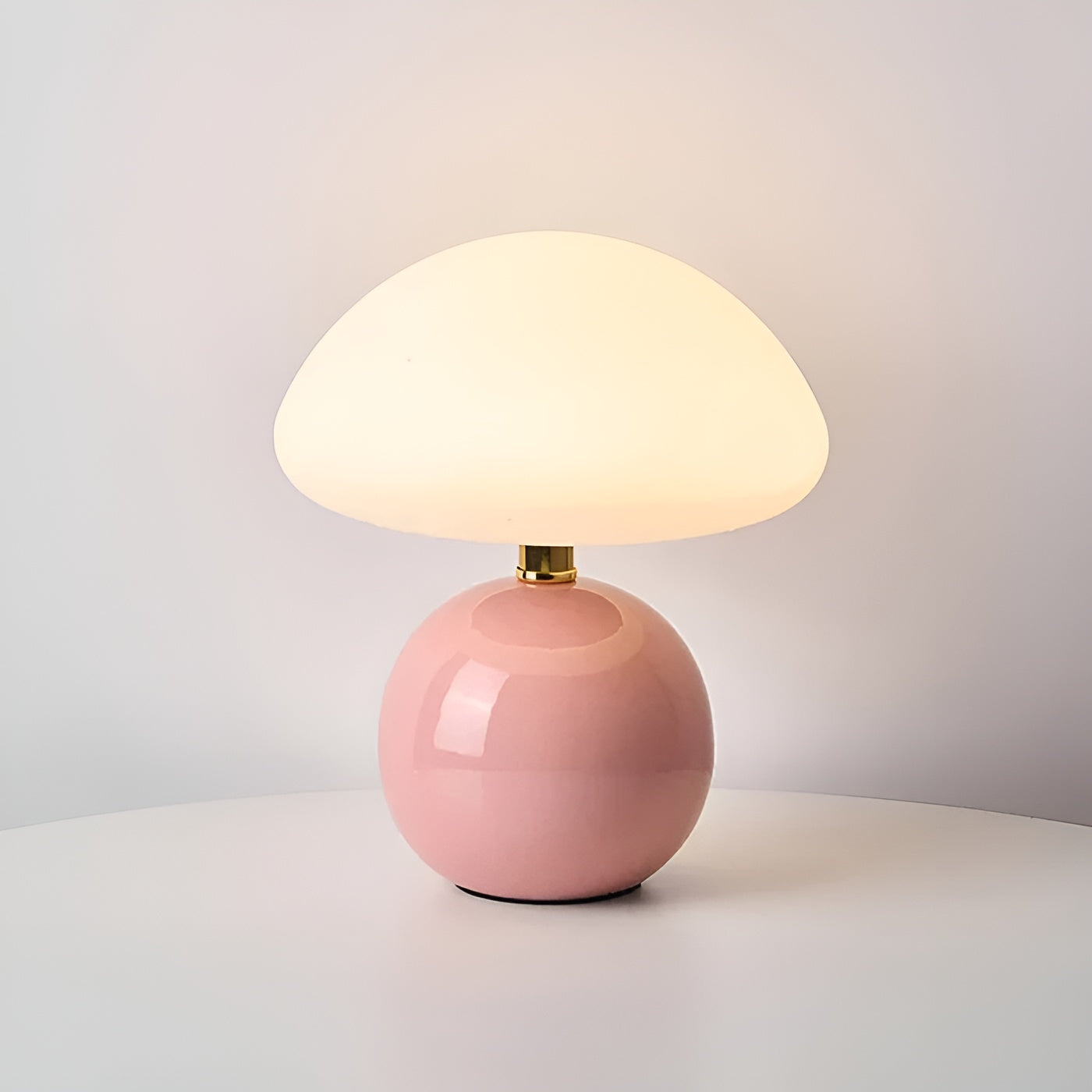 Pink spherical base table lamp with translucent dome diffuser