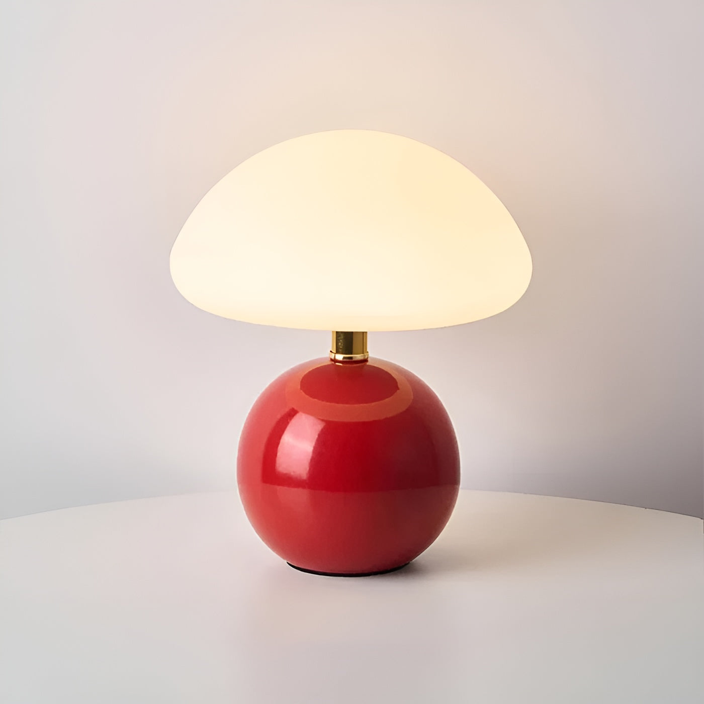 Red glossy spherical base table lamp with gold collar and dome diffuser