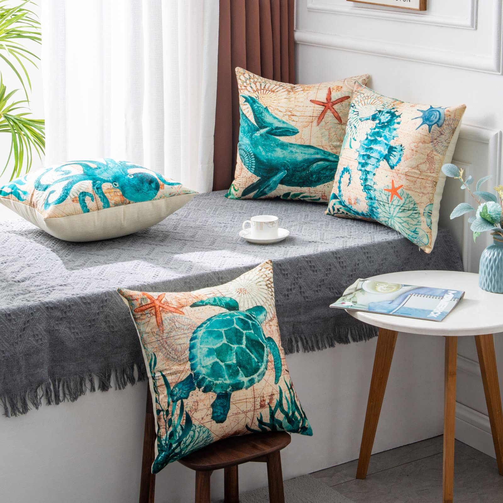 Lifestyle shot of four marine life throw pillows on window seat