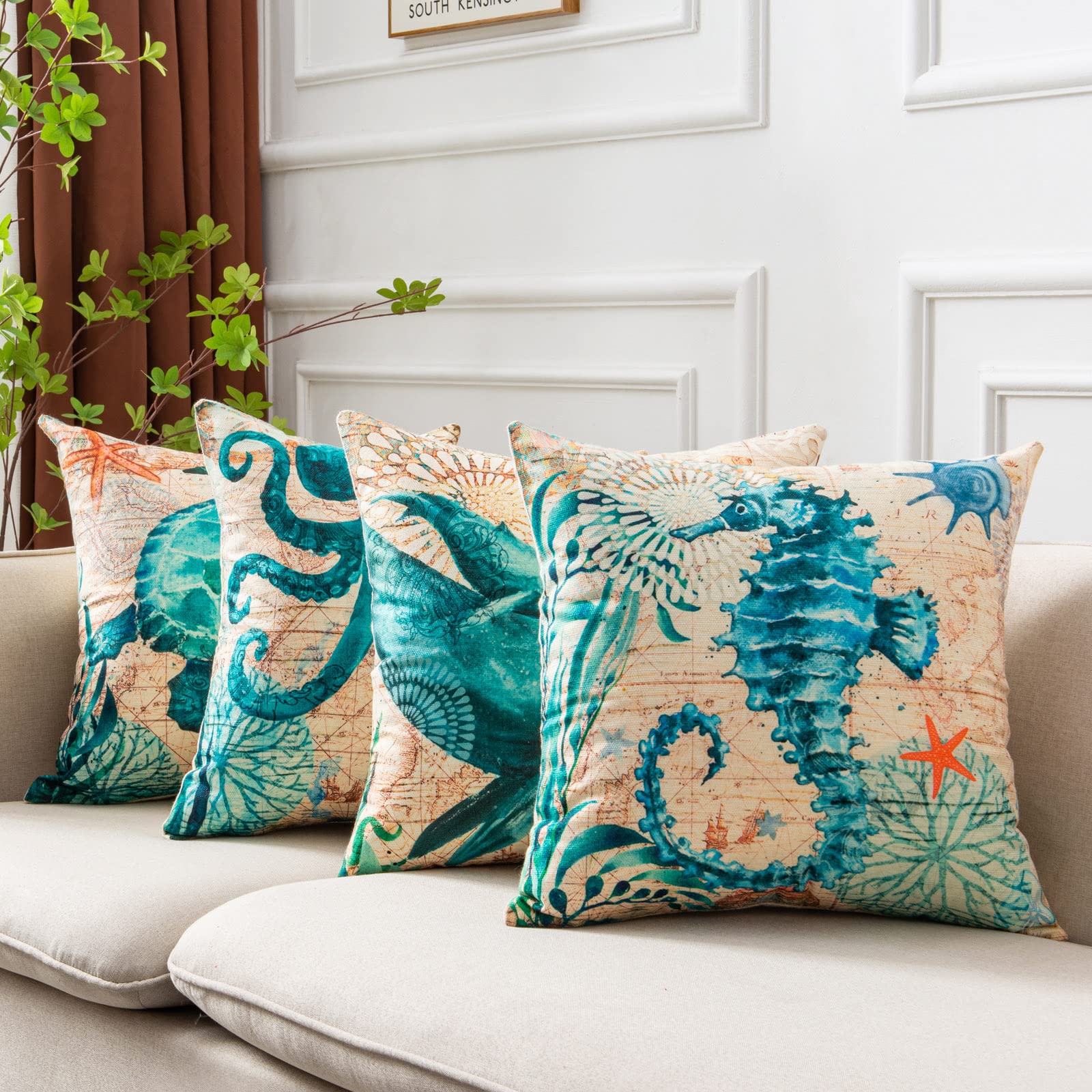 Teal octopus, whale, and seahorse pillow covers on beige sofa