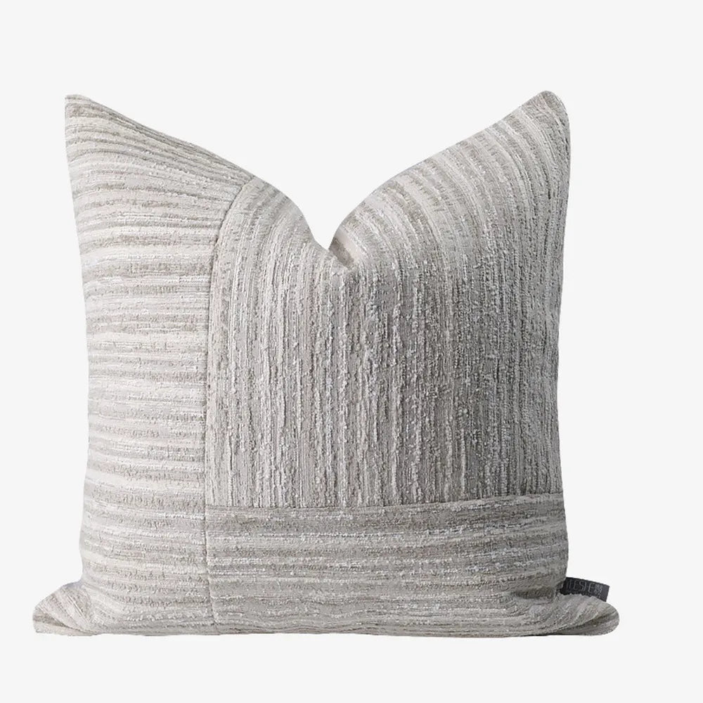 Symmetrical geometric patchwork design on luxury neutral model room decorative cushion