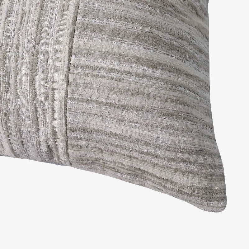 Detailed corner view of nubby chenille and vertical ribbed patchwork sofa accent pillow