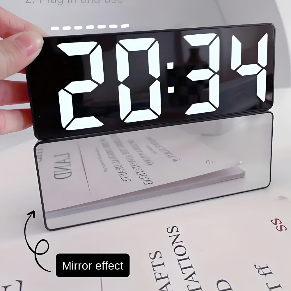 Digital alarm clock demonstrating reflective mirror back surface effect