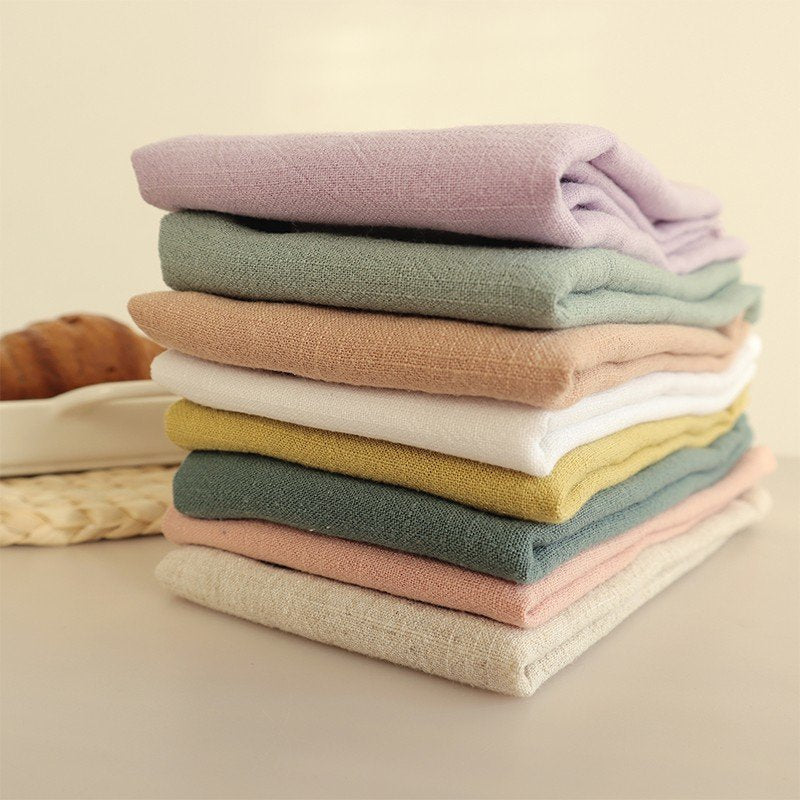 Stack of eight earth tone cotton linen napkins in muted colors