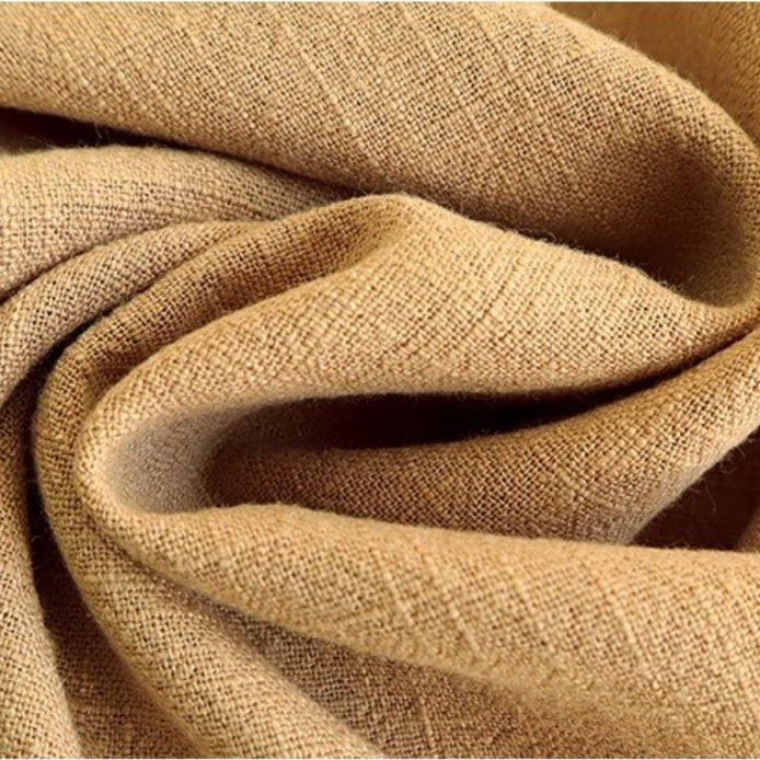 Beige cotton linen napkin close-up showing textured weave and soft natural fiber